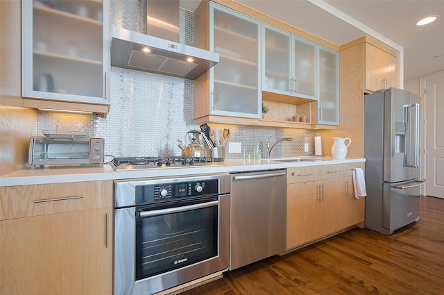 2207 Bancroft St Unit 604, Houston, TX 77027 - kitchen with appliances with stainless steel finishes, wall chimney range hood, a sink, light brown cabinets, and recessed lighting