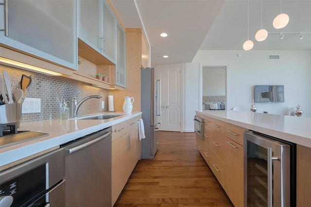 2207 Bancroft St Unit 604, Houston, TX 77027 - kitchen featuring beverage cooler, stainless steel appliances, a sink, light countertops, and dark wood finished floors