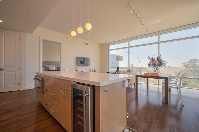 2207 Bancroft St Unit 604, Houston, TX 77027 - kitchen with beverage cooler, rail lighting, dark wood finished floors, plenty of natural light, and a wall of windows