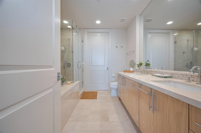 2207 Bancroft St Unit 604, Houston, TX 77027 - bathroom with a stall shower, double vanity, tile patterned floors, recessed lighting, and toilet
