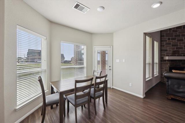 2498 Diamond D Dr, Beaumont, TX 77713 - dining area with dark wood-style flooring and baseboards