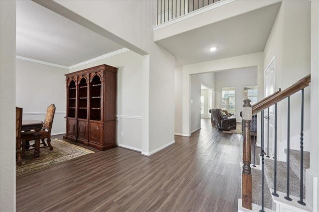 2498 Diamond D Dr, Beaumont, TX 77713 - entrance foyer featuring stairway, wood finished floors, baseboards, and ornamental molding