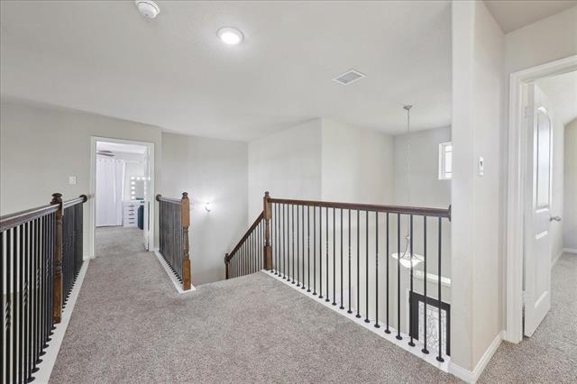 2498 Diamond D Dr, Beaumont, TX 77713 - hallway with carpet flooring, an upstairs landing, and baseboards