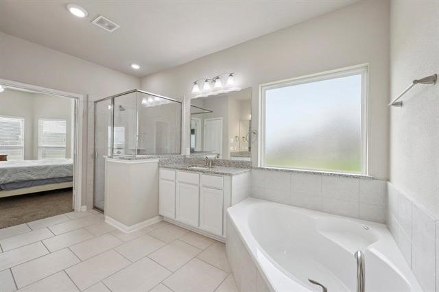 2498 Diamond D Dr, Beaumont, TX 77713 - bathroom featuring plenty of natural light, a stall shower, a garden tub, and vanity