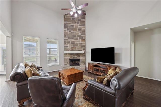 2498 Diamond D Dr, Beaumont, TX 77713 - living area with high vaulted ceiling, a ceiling fan, wood finished floors, a stone fireplace, and baseboards