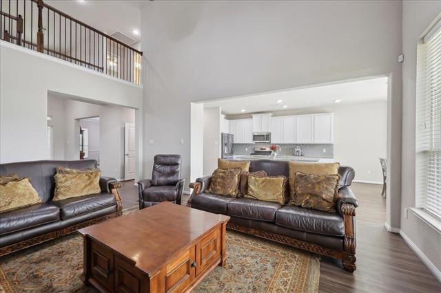2498 Diamond D Dr, Beaumont, TX 77713 - living area featuring wood finished floors, a high ceiling, recessed lighting, healthy amount of natural light, and baseboards