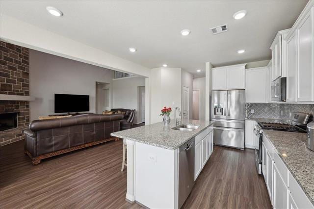 2498 Diamond D Dr, Beaumont, TX 77713 - kitchen with appliances with stainless steel finishes, a sink, open floor plan, light stone countertops, and recessed lighting