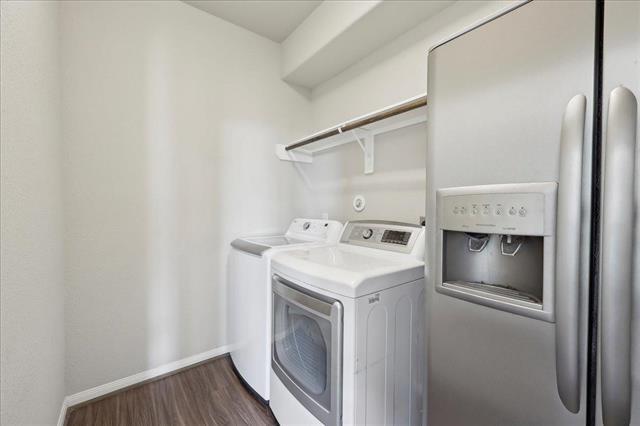 2498 Diamond D Dr, Beaumont, TX 77713 - clothes washing area with washing machine and clothes dryer, dark wood-style floors, and baseboards