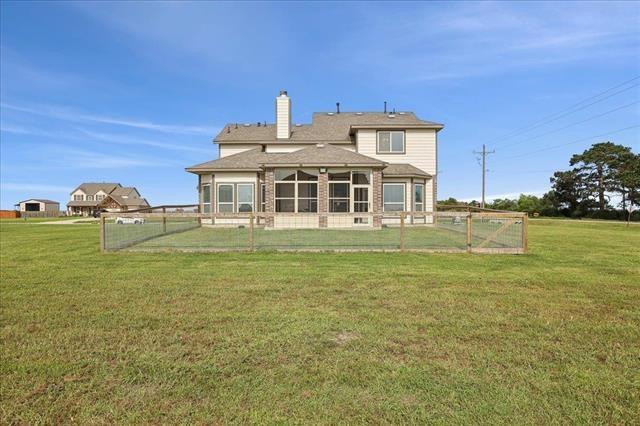 2498 Diamond D Dr, Beaumont, TX 77713 - rear view of house with a chimney and a sunroom