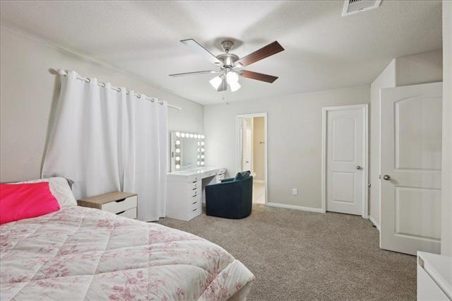 2498 Diamond D Dr, Beaumont, TX 77713 - carpeted bedroom featuring ceiling fan and baseboards