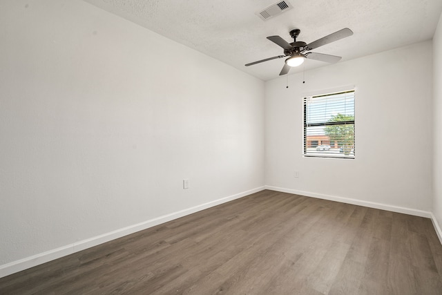 404 Glenmore Dr, Pasadena, TX 77503 - spare room with dark wood-type flooring, baseboards, a ceiling fan, and a textured ceiling