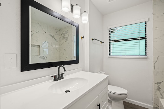 404 Glenmore Dr, Pasadena, TX 77503 - full bath featuring vanity, toilet, a marble finish shower, wood finished floors, and baseboards
