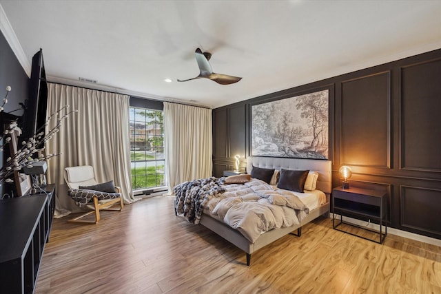 24615 Mount Auburn Dr, Katy, TX 77494 - bedroom featuring a decorative wall, crown molding, light wood-style floors, and ceiling fan
