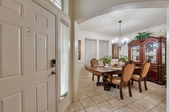 13111 Porter Meadow Ln, Houston, TX 77014 - dining space with a chandelier, crown molding, light tile patterned floors, healthy amount of natural light, and baseboards