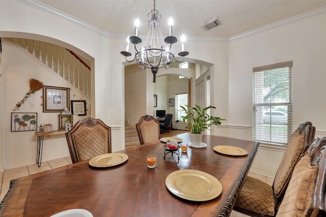 13111 Porter Meadow Ln, Houston, TX 77014 - dining space featuring tile patterned floors, arched walkways, ornamental molding, a chandelier, and stairway