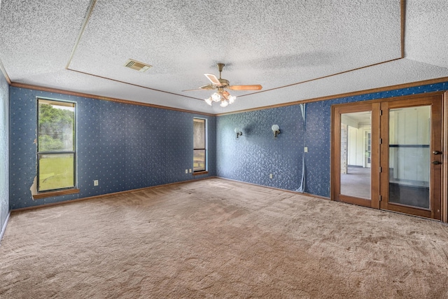 207 Oak Hill Dr, Brenham, TX 77833 - empty room featuring ornamental molding, a textured ceiling, carpet floors, a ceiling fan, and wallpapered walls