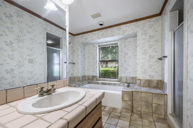 207 Oak Hill Dr, Brenham, TX 77833 - bathroom featuring crown molding, a textured ceiling, a stall shower, a bath, and vanity