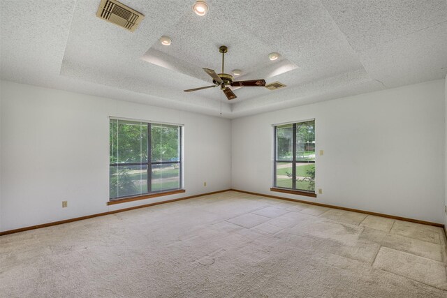 207 Oak Hill Dr, Brenham, TX 77833 - carpeted spare room with healthy amount of natural light, baseboards, a textured ceiling, and a ceiling fan