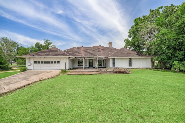 207 Oak Hill Dr, Brenham, TX 77833 - ranch-style home with an attached garage, driveway, board and batten siding, and a chimney