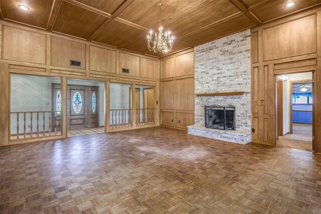 207 Oak Hill Dr, Brenham, TX 77833 - unfurnished living room with wood ceiling, a towering ceiling, a chandelier, a decorative wall, and a brick fireplace