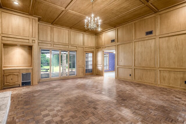 207 Oak Hill Dr, Brenham, TX 77833 - unfurnished living room featuring wooden ceiling, a decorative wall, a chandelier, and a high ceiling