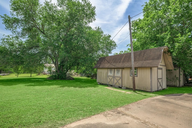 207 Oak Hill Dr, Brenham, TX 77833 - view of green lawn with a storage shed and an outdoor structure