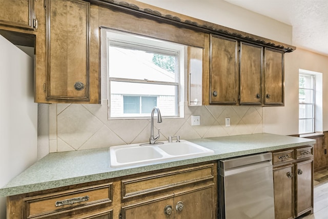 28902 Twisted Oak Dr, Shenandoah, TX 77381 - kitchen featuring stainless steel dishwasher, a sink, backsplash, and healthy amount of natural light