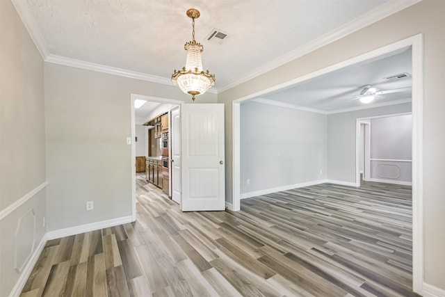 28902 Twisted Oak Dr, Shenandoah, TX 77381 - empty room featuring a chandelier, wood finished floors, crown molding, and baseboards