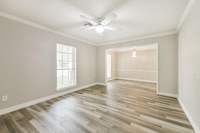 28902 Twisted Oak Dr, Shenandoah, TX 77381 - spare room with light wood finished floors, a textured ceiling, a ceiling fan, crown molding, and baseboards