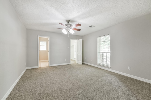 28902 Twisted Oak Dr, Shenandoah, TX 77381 - spare room featuring a ceiling fan, a textured ceiling, light carpet, and baseboards