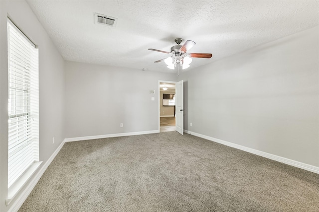 28902 Twisted Oak Dr, Shenandoah, TX 77381 - unfurnished bedroom with carpet flooring, baseboards, a textured ceiling, and ceiling fan