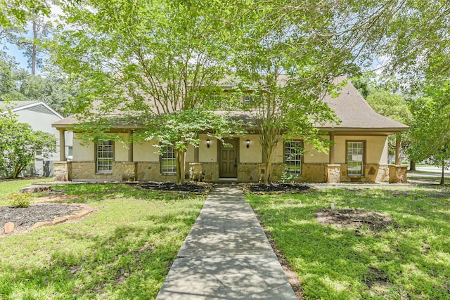 28902 Twisted Oak Dr, Shenandoah, TX 77381 - view of front facade with stone siding, stucco siding, and a front lawn