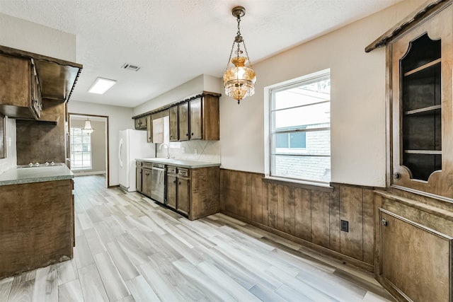 28902 Twisted Oak Dr, Shenandoah, TX 77381 - kitchen with a wainscoted wall, a chandelier, dishwasher, light wood finished floors, and freestanding refrigerator