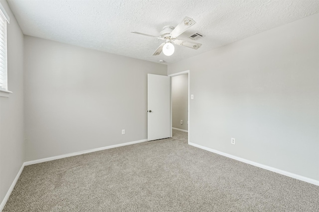 28902 Twisted Oak Dr, Shenandoah, TX 77381 - spare room with light colored carpet, ceiling fan, baseboards, and a textured ceiling