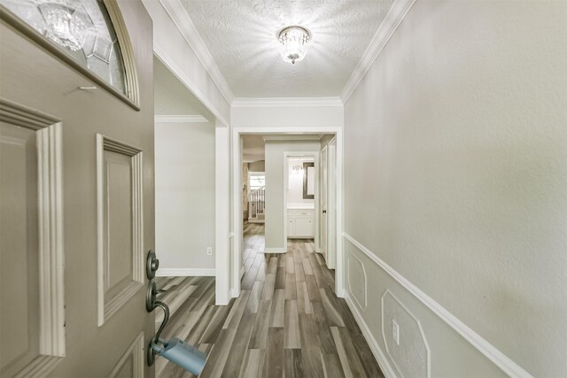 28902 Twisted Oak Dr, Shenandoah, TX 77381 - corridor with dark wood-style floors, a textured ceiling, ornamental molding, and baseboards