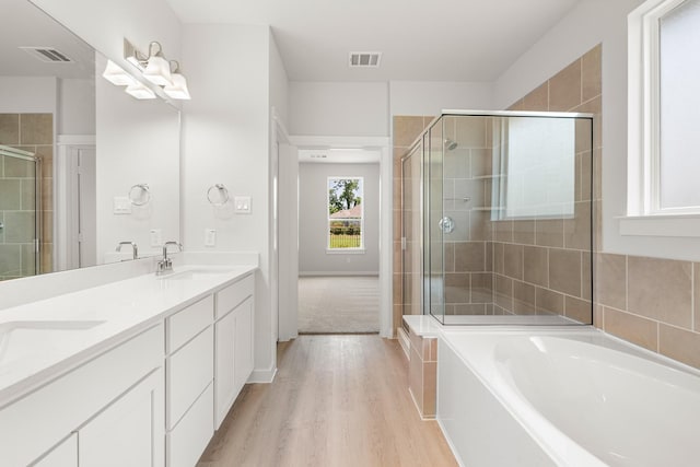 33019 School Hill Rd, Fulshear, TX 77441 - full bath with a stall shower, wood finished floors, a garden tub, and double vanity