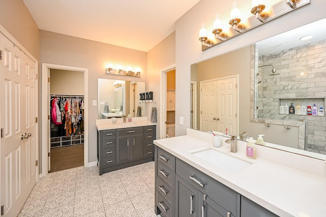 13907 Pawnee Trails Dr, Cypress, TX 77429 - bathroom featuring walk in shower, two vanities, tile patterned flooring, and a spacious closet