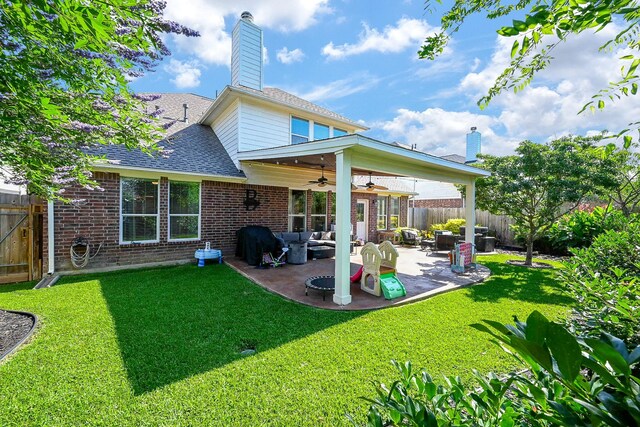 13907 Pawnee Trails Dr, Cypress, TX 77429 - back of property featuring a ceiling fan, brick siding, outdoor lounge area, and a patio