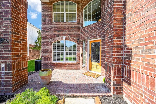 13907 Pawnee Trails Dr, Cypress, TX 77429 - doorway to property with brick siding and a patio area