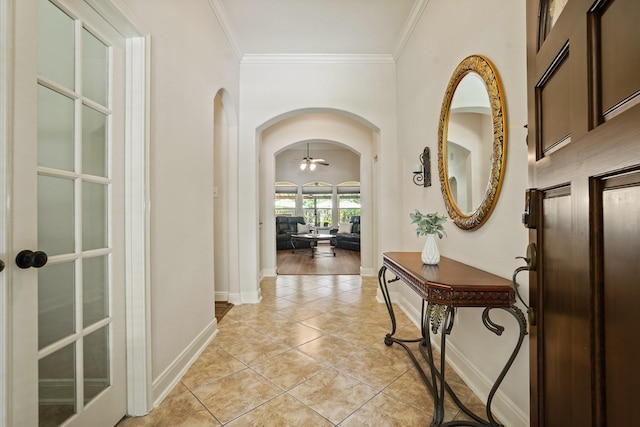 6123 Cypress Way Dr, Magnolia, TX 77354 - hallway with arched walkways, baseboards, crown molding, and light tile patterned floors