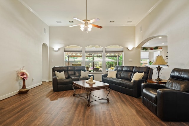 6123 Cypress Way Dr, Magnolia, TX 77354 - living area featuring arched walkways, ceiling fan, wood finished floors, a towering ceiling, and crown molding