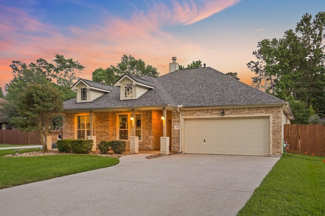 6123 Cypress Way Dr, Magnolia, TX 77354 - view of front of house with brick siding, concrete driveway, a garage, and a chimney