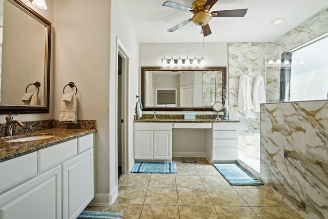 6123 Cypress Way Dr, Magnolia, TX 77354 - bathroom with a ceiling fan, two vanities, tile patterned flooring, and a marble finish shower