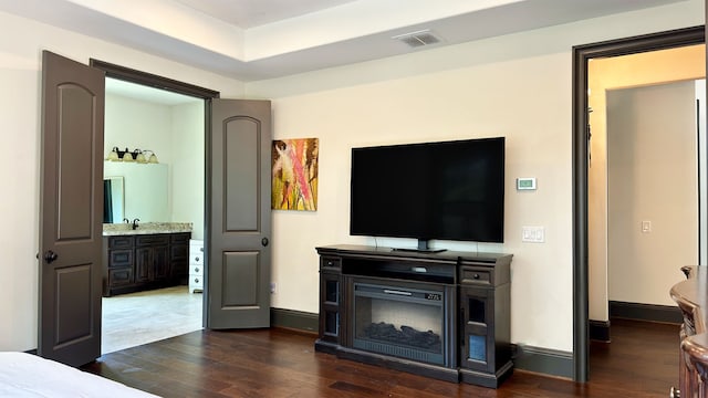 4818 Lake Village Dr, Fulshear, TX 77441 - bedroom with dark wood-style floors, connected bathroom, and baseboards
