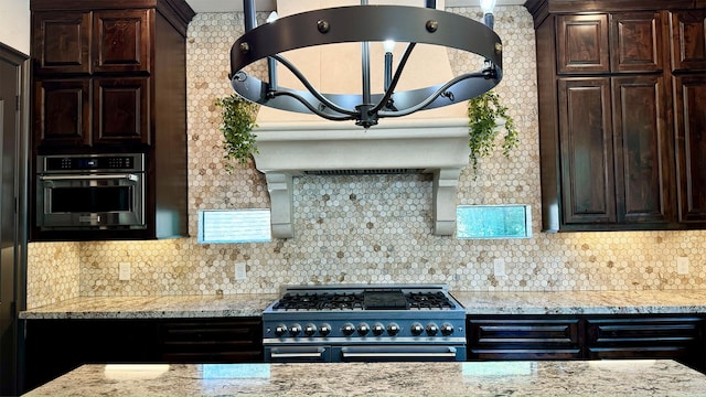 4818 Lake Village Dr, Fulshear, TX 77441 - kitchen with double oven range, dark brown cabinets, wall oven, and backsplash