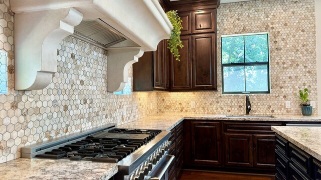 4818 Lake Village Dr, Fulshear, TX 77441 - kitchen featuring a sink, high end stainless steel range oven, backsplash, and dark brown cabinets