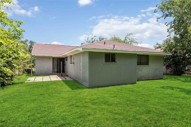 11750 Murr Way, Houston, TX 77048 - back of property with brick siding, a patio, and a lawn