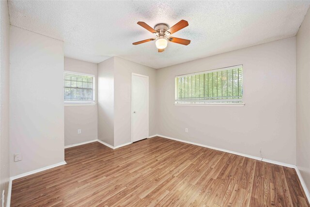 11750 Murr Way, Houston, TX 77048 - unfurnished bedroom with light wood finished floors, baseboards, a textured ceiling, ceiling fan, and a closet