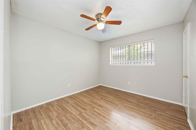 11750 Murr Way, Houston, TX 77048 - spare room featuring light wood-type flooring, a textured ceiling, baseboards, and ceiling fan