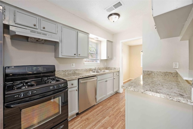 11750 Murr Way, Houston, TX 77048 - kitchen with dishwasher, black range with gas stovetop, a sink, under cabinet range hood, and light wood-type flooring